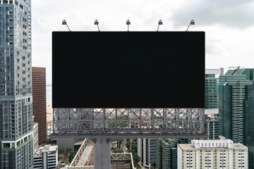 Obraz premium Blank black road billboard with Singapore cityscape background at day time. Street advertising poster, mock up, 3D rendering. Front view. The concept of marketing communication to promote.