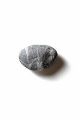 Single pebble on a white background