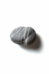 Single pebble on a white background