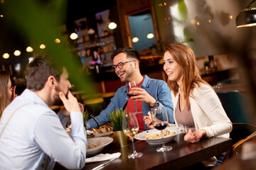 Young people having dinner in the restaurant