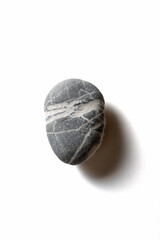 Single pebble on a white background