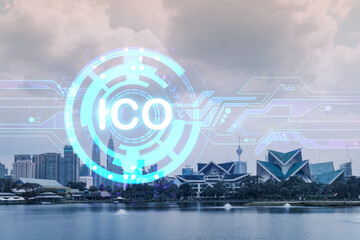 ICO icon hologram over panorama city view of Kuala Lumpur. KL is the hub of blockchain projects in...