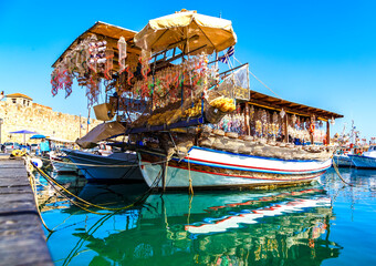 Fototapeta na wymiar wooden boat shop selling seashells and decorations from sea, Greece, Rhodes, port of Mandraki
