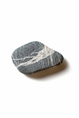 Single pebble on a white background