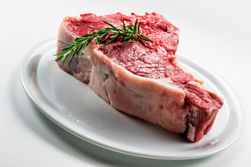 Raw T-bone steak with rosemary