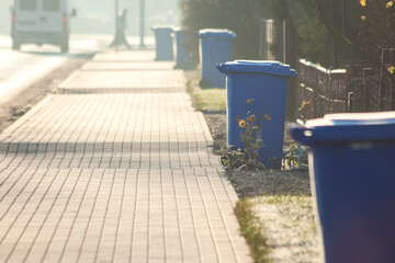 Garbage cans in line on the side of the road. Environmental protection concept