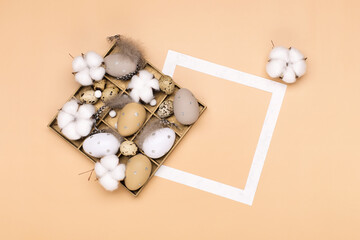 Easter eggs on beige pastel background with space for text. Flat lay image composition, top view.