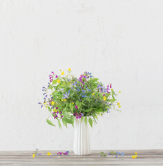 summer wild flowers in vase on white background