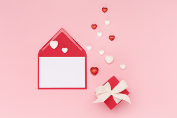 Glitter hearts, empty card and red gift box on pink background. Valentines day concept. Flat lay, top view, copy space.