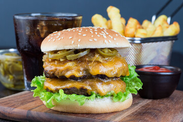 Double cheese burger with two beef patty, cheddar cheese, lettuce, caramelized onion and jalapeno...