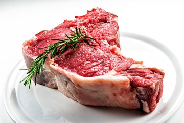 Raw T-bone steak with rosemary