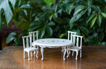 Small set of chairs and table - dollhouse furniture in green, jungle environment