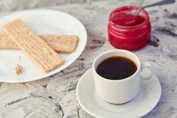 Crispbread with jam for Breakfast on a gray background. A jar of Fresh Honey with foam is next to a Cup of coffee. A minimum of calories. proper nutrition