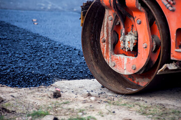 Construction site is laying new asphalt road pavement,road construction workers and road construction machinery scene.