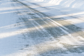 Snowy icy road. Danger of winter travel by road from ice