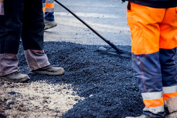 New asphalt laying. Road construction workers and road construction machinery scene, new asphalt road
