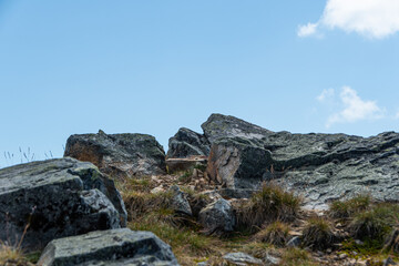 Boulders of ridge against sky. Rock climbing and mountain travel