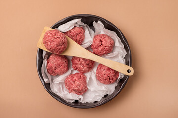 Frying Pan with Raw Meatballs on the Light Brown Background Semifinished Food Top View Horizontal
