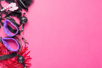 Intimate sex games. BDSM Tools dildo vibrator, gag, nipple clamps, handcuffs, whip and other on red...