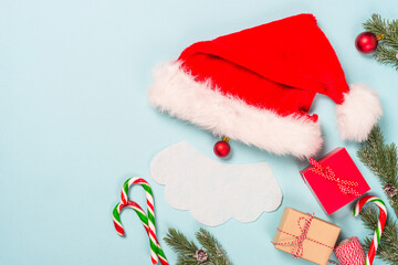 Creative christmas composition with Santa and presents. Flat lay image on blue background.
