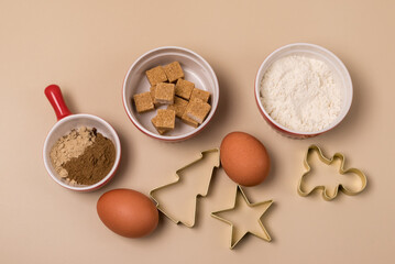 Cut out Gingerbread Cookie Form in the Shape of a Christmas Tree Star and Gingerbread Man and Ingredients for Cookies Eggs Flour Sugar Spices