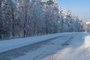 Obraz premium Snowy icy road. Danger of winter travel by road from ice