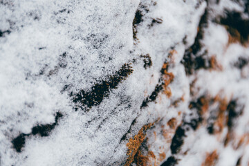 Stone wall with touch of frost on winter day