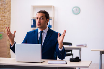 Young male employee working in the office