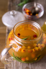 Tasty and Hot Tea from Berries of a Sea Buckthorn and Fresh Rosemary Cozy Hot Beverage Wooden Background Close Up Above