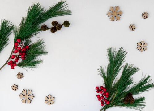 Christmas Composition Concept. Pine branches and ilex berries on white background. Flat lay, top view.