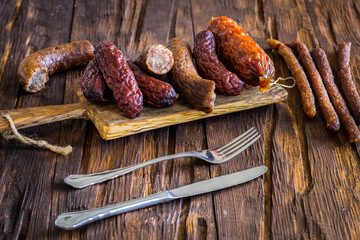 Various kinds of appetizing cold cuts on an old wooden table