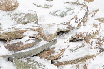 Stone wall with touch of frost on winter day