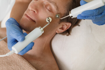 Cropped shot of a mature male client getting facial electrolysis skincare procedure at beauty clinic
