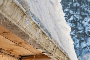 Frozen roof under snow in winter weather