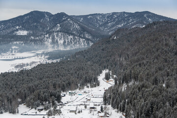 Winter forest landscape with snow sloping hills on horizon