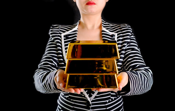 Business Woman Holding The Gold Bar On The Background