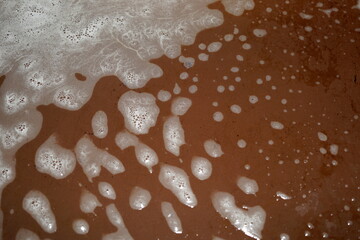 Foam from detergent on the turn of the tray