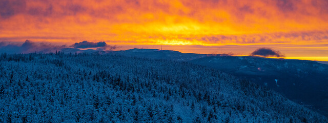 Stunning view panorama of snowy frozen dusty mountain sunset landscape in winter in Black Forest -...