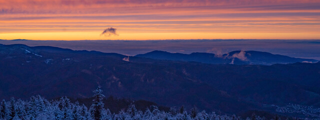 Stunning view panorama of snowy frozen dusty mountain sunset landscape in winter in Black Forest -...