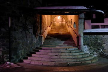 Obraz premium Stairs next to church by night in Sexten (Sesto) in Dolomites in Italy 