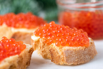 Christmas, New Year appetizer canape with red caviar and baguette bread