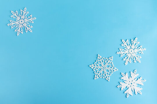 Christmas or winter composition. Pattern made of white snowflakes on pastel blue background. Christmas, winter, new year concept. Flat lay, top view, copy space