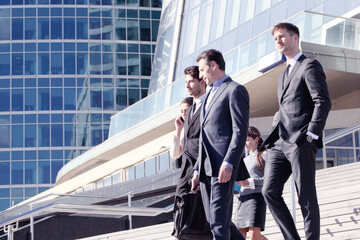 Business people walking down stairs