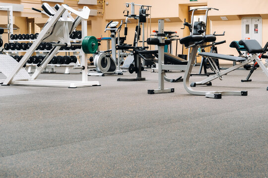 Bright Gym. Sports Equipment In The Gym. Bars Of Different Weights On The Rack.Trainers