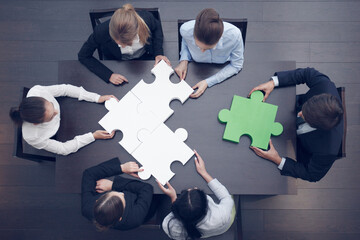 Business people assembling puzzle
