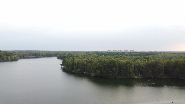 Up and down on lake with trees on the side. Green tree leaf formation .