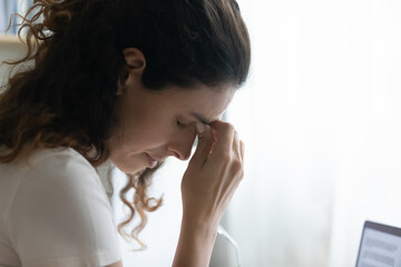 Close up unhappy tired young woman massaging touching nose bridge, feeling fatigue, exhausted...