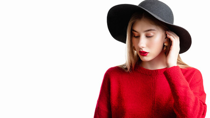 Casual boho. Trend fashion. Female model. Hipster style. Beautiful woman in red sweater black straw hat posing isolated on white copy space.