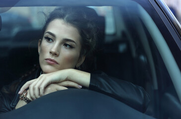 Fototapeta na wymiar Beautiful girl driving a car