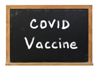 Fototapeta premium Covid Vaccine written in white chalk on a black chalkboard isolated on white